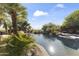 Backyard pool with a cascading waterfall feature surrounded by lush greenery and landscaping at 13249 E Summit Dr, Scottsdale, AZ 85259