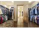 A large walk-in closet with custom shelving provides ample storage space for clothing and accessories at 13249 E Summit Dr, Scottsdale, AZ 85259
