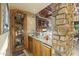 Stylish wet bar with custom cabinetry, granite counters, and a unique wine storage area at 13249 E Summit Dr, Scottsdale, AZ 85259