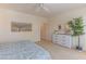 Neutral bedroom features soft carpeting, accent artwork, with a full sized bed and bright natural light at 15353 W Cheery Lynn Rd, Goodyear, AZ 85395