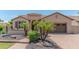 Beautiful single-story home with lush landscaping, a charming entrance, and a paved driveway at 15353 W Cheery Lynn Rd, Goodyear, AZ 85395