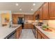 Bright kitchen with wood cabinets, stainless steel appliances, stone countertops, and plenty of counter space at 15353 W Cheery Lynn Rd, Goodyear, AZ 85395