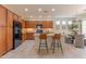 Well-lit kitchen with wood cabinets, modern appliances, and center island with bar seating and garden view at 15353 W Cheery Lynn Rd, Goodyear, AZ 85395