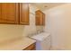 Functional laundry room with storage cabinets and white washer and dryer units at 15353 W Cheery Lynn Rd, Goodyear, AZ 85395