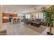 Open-concept living area featuring tile flooring, a comfortable seating arrangement, and access to the dining area at 15353 W Cheery Lynn Rd, Goodyear, AZ 85395