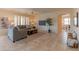 Comfortable living room with tile floors, neutral colors, and large windows offering plenty of natural light at 15353 W Cheery Lynn Rd, Goodyear, AZ 85395