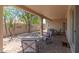 Spacious covered patio with brick flooring, patio furniture, and views of the private backyard at 15353 W Cheery Lynn Rd, Goodyear, AZ 85395