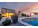 An expansive backyard featuring a sparkling pool, well-maintained landscaping, and an inviting covered patio at 1647 W Gold Mine Way, San Tan Valley, AZ 85144