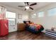 A cozy bedroom with a basketball theme, wood floors, natural light, and playful decor at 1647 W Gold Mine Way, San Tan Valley, AZ 85144