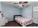 Bedroom with ceiling fan, laminate floors, and window with natural light at 1647 W Gold Mine Way, San Tan Valley, AZ 85144