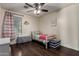 Bright bedroom features laminate floors, ceiling fan, and window with natural light at 1647 W Gold Mine Way, San Tan Valley, AZ 85144