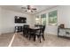 Bright dining room with a modern ceiling fan, tile flooring, and a dining table that seats six at 1647 W Gold Mine Way, San Tan Valley, AZ 85144