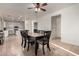 Bright dining room with tile flooring and a modern table; kitchen and doorway in the background at 1647 W Gold Mine Way, San Tan Valley, AZ 85144