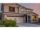 Close-up of a two-story home with neutral colors and dark trim at 1647 W Gold Mine Way, San Tan Valley, AZ 85144