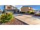 Suburban two-story home featuring a long driveway and desert landscaping at 1647 W Gold Mine Way, San Tan Valley, AZ 85144