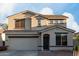 Exterior view of a two-story home with an attached garage and landscaped front yard at 1647 W Gold Mine Way, San Tan Valley, AZ 85144