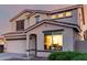 Two-story home with an attached garage and landscaping at 1647 W Gold Mine Way, San Tan Valley, AZ 85144