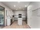 Modern kitchen with white cabinets, stainless steel appliances, and subway tile backsplash at 1647 W Gold Mine Way, San Tan Valley, AZ 85144