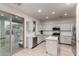Bright kitchen with white cabinets, stainless steel appliances, and a tile backsplash; sliding glass doors on side at 1647 W Gold Mine Way, San Tan Valley, AZ 85144