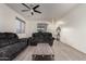 Comfortable living room with tile flooring, a ceiling fan, and a plush reclining sofa for relaxation at 1647 W Gold Mine Way, San Tan Valley, AZ 85144