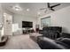 Spacious living room with tile flooring, a modern ceiling fan, and a comfortable reclining sofa at 1647 W Gold Mine Way, San Tan Valley, AZ 85144
