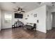 Bright living room with dark wood floors, a comfortable couch, and decor adding a playful touch to the space at 1647 W Gold Mine Way, San Tan Valley, AZ 85144