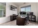 Functional home office with natural light, tile floors, and ample workspace for productivity at 1647 W Gold Mine Way, San Tan Valley, AZ 85144