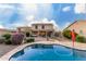 Backyard with pool, outdoor seating and lush landscaping, perfect for enjoying the Arizona sunshine at 1647 W Gold Mine Way, San Tan Valley, AZ 85144