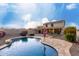 Beautiful backyard features a refreshing pool, patio area, and manicured landscaping at 1647 W Gold Mine Way, San Tan Valley, AZ 85144