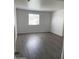 Bright bedroom featuring a large window, modern flooring, and fresh paint, creating a serene atmosphere at 16602 N 25Th St # 123, Phoenix, AZ 85032