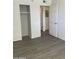 A bright and well-lit bedroom with hardwood flooring and a built in closet with an open door frame to the hallway at 16602 N 25Th St # 123, Phoenix, AZ 85032