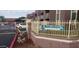 View of the Autumn Park Condominium sign and community buildings behind a fence with a vehicle parked nearby at 16602 N 25Th St # 123, Phoenix, AZ 85032