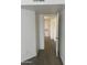 A bright and well-lit hallway with hardwood flooring and fresh paint, offering an open door frame to the bedroom at 16602 N 25Th St # 123, Phoenix, AZ 85032