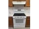 Close-up of a clean white range oven with modern features and marble countertops at 16602 N 25Th St # 123, Phoenix, AZ 85032