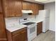 A bright kitchen featuring wood cabinets, modern appliances and white marble-style countertops offering ample counter space at 16602 N 25Th St # 123, Phoenix, AZ 85032