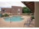 Community swimming pool with lounge chairs and well-maintained landscaping at 16602 N 25Th St # 123, Phoenix, AZ 85032
