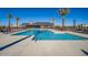 Large community pool with lounge chairs and palm trees for a resort-style experience at 16963 W Poinsettia Dr, Surprise, AZ 85388