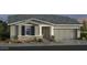 Beautiful single-story home with neutral paint, stone accents, covered entry, and a two-car garage at 16963 W Poinsettia Dr, Surprise, AZ 85388