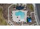 Top-down shot of community pool area boasting pristine swimming pool, sun loungers and umbrellas at 17812 W Luke Ave, Litchfield Park, AZ 85340