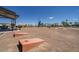 Community picnic area with grills, tables, playground, and space for games at 17812 W Luke Ave, Litchfield Park, AZ 85340
