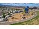 Playground with shade structures and various swings and play equipment for outdoor fun, including slides and climbing at 17812 W Luke Ave, Litchfield Park, AZ 85340