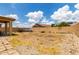 A large backyard with a patio and stone landscaping, surrounded by a block wall fence at 18102 E El Viejo Desierto --, Gold Canyon, AZ 85118