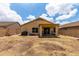 A spacious backyard with a covered patio area, xeriscape landscaping, and a high block wall fence for privacy at 18102 E El Viejo Desierto --, Gold Canyon, AZ 85118