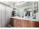A bathroom vanity features wood cabinets, a white countertop, and a large mirror with a view into the adjacent room at 18102 E El Viejo Desierto --, Gold Canyon, AZ 85118