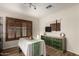 Dining room with wooden floors, shuttered window, and modern green buffet at 18102 E El Viejo Desierto --, Gold Canyon, AZ 85118