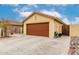 A tan house with brown garage door, tile roof, and paved driveway at 18102 E El Viejo Desierto --, Gold Canyon, AZ 85118