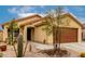 Inviting front entrance of tan home with desert landscaping, barrel cactus, and iron security door at 18102 E El Viejo Desierto --, Gold Canyon, AZ 85118