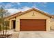 Charming tan single-story home with a brown two-car garage at 18102 E El Viejo Desierto --, Gold Canyon, AZ 85118