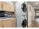 A well-organized laundry room with stacked washer and dryer, custom cabinets, and a convenient layout at 18102 E El Viejo Desierto --, Gold Canyon, AZ 85118