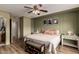 Comfortable bedroom with ceiling fan, wood floors, and decorative wall art at 18102 E El Viejo Desierto --, Gold Canyon, AZ 85118